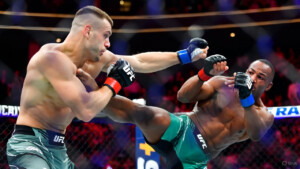 Aspinall vs. Gane mid-fight at UFC 321, showcasing power vs. precision in a thrilling heavyweight clash."